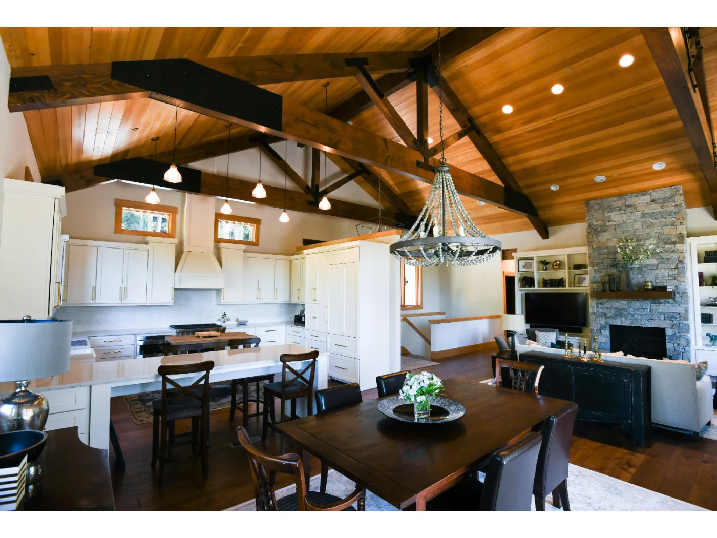 Issaquah great room: dining under a vaulted timber ceiling