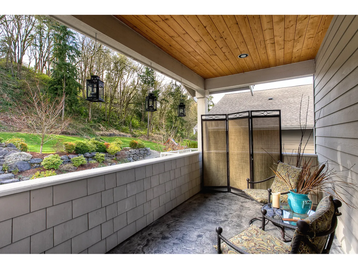 Kent home: covered patio with a stone wall
